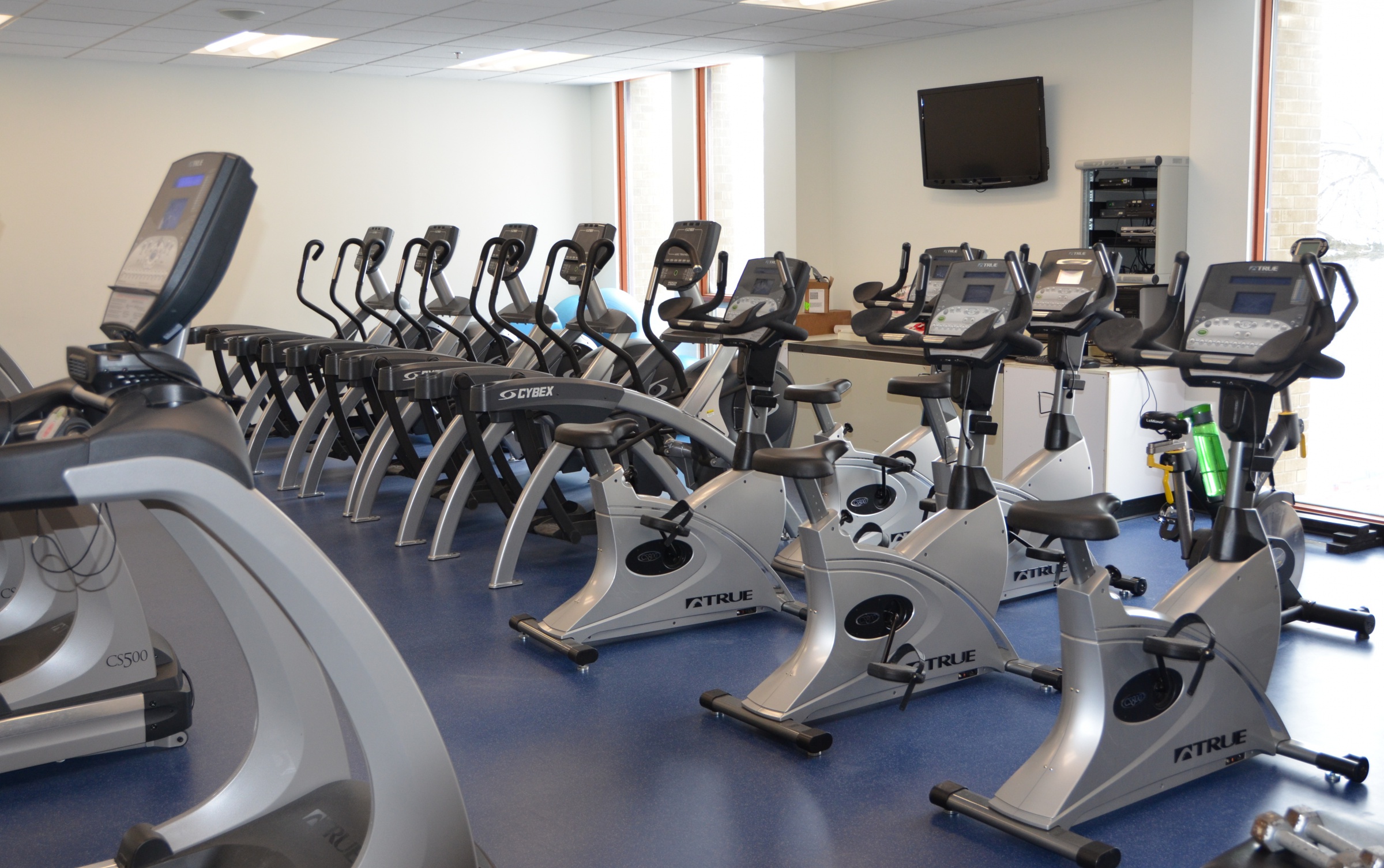 A row of exercise equipment in the St. Mary's Academy fitness room.
