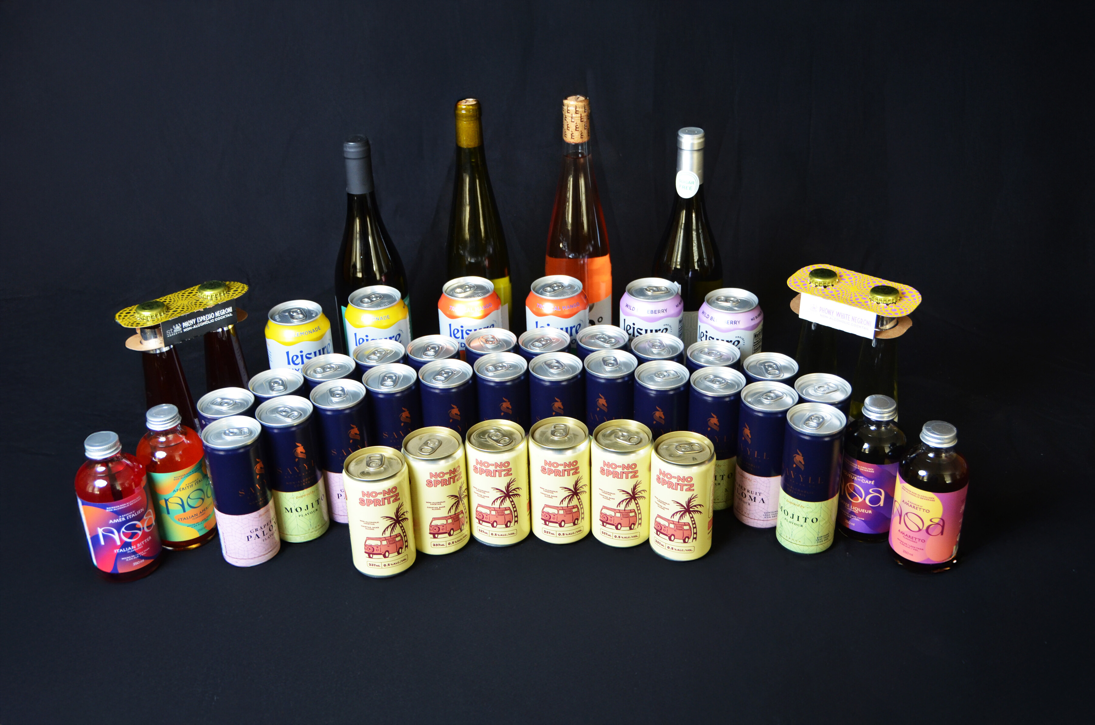 a group of different alcoholic and non-alcoholic drinks on a black background