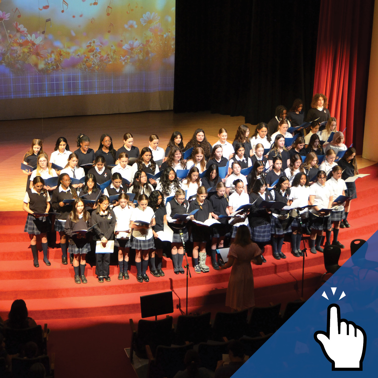 A group of St. Mary's Academy student performing a concert on stage.