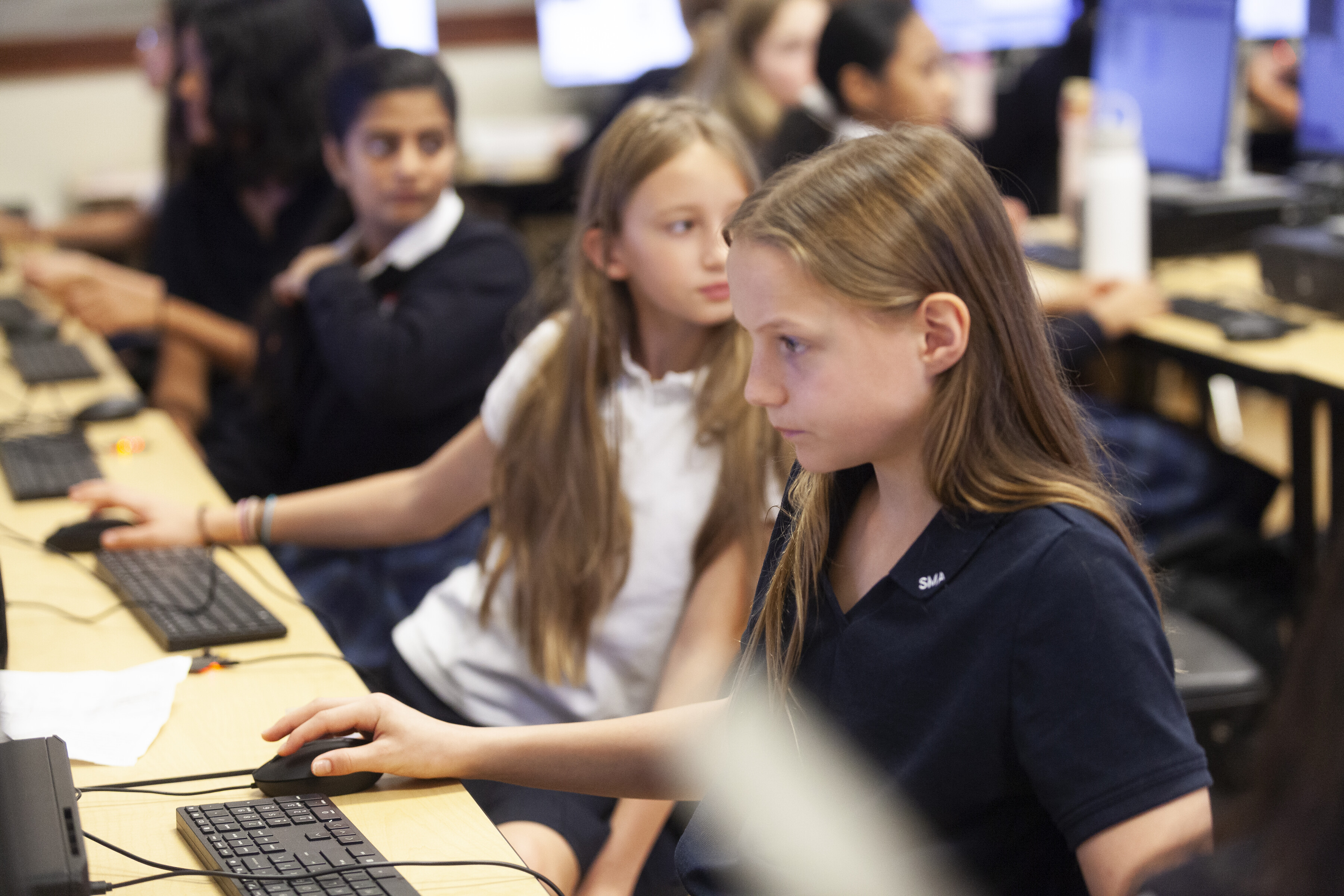A group grade 7 students using computers for their school work