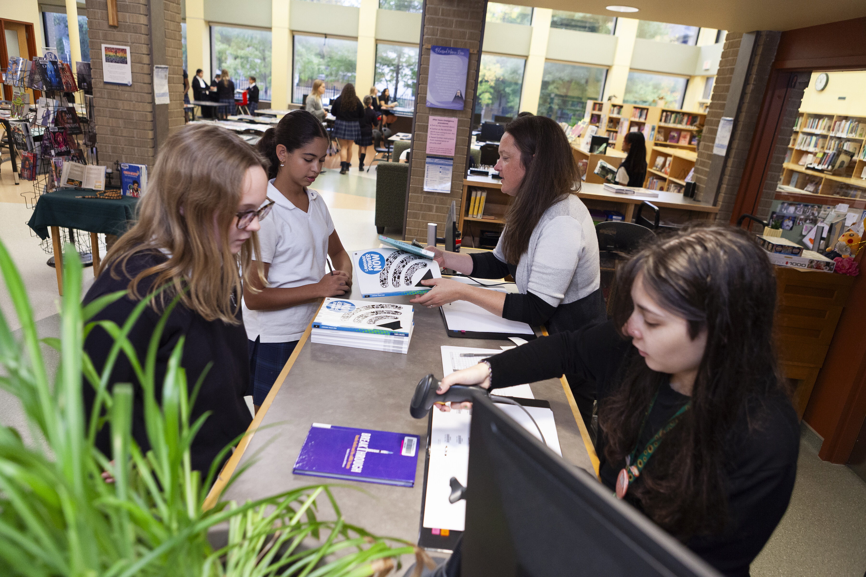 Two SMA students borrowing books from the library