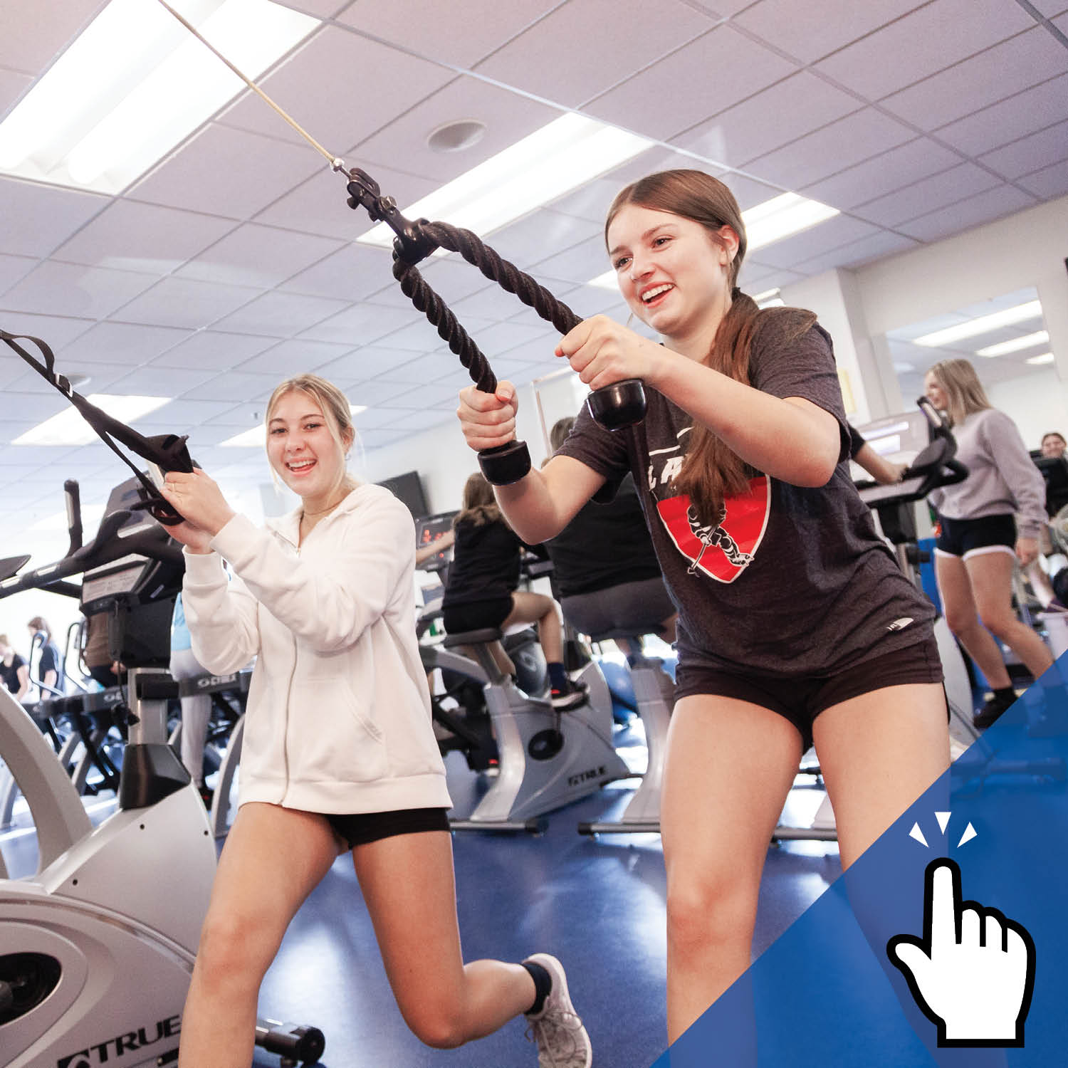 Two St. Mary's Academy students dressed in fitness attire exercise.