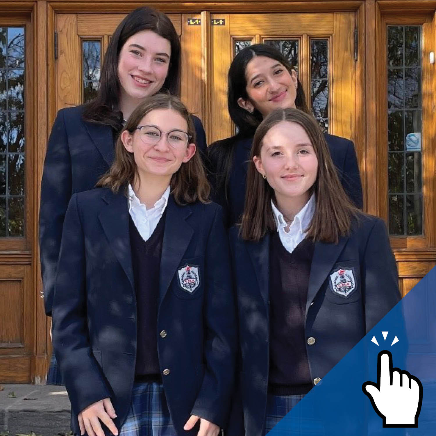 Four St. Mary's Academy students in uniform stand in front of the doors.