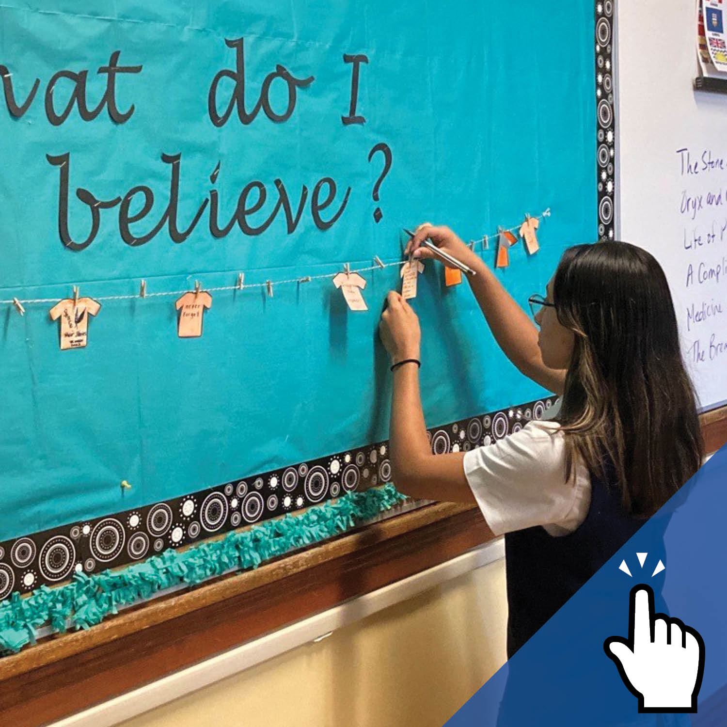 A St. Mary's Academy student engages in a creative activity on a board, with 'What do I believe?' written on it.